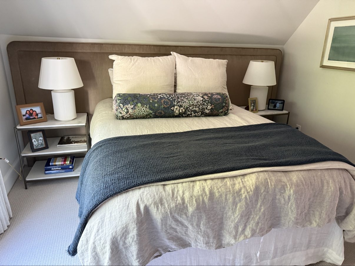 Wide taupe headboard wall with floral bolster — top hero choice