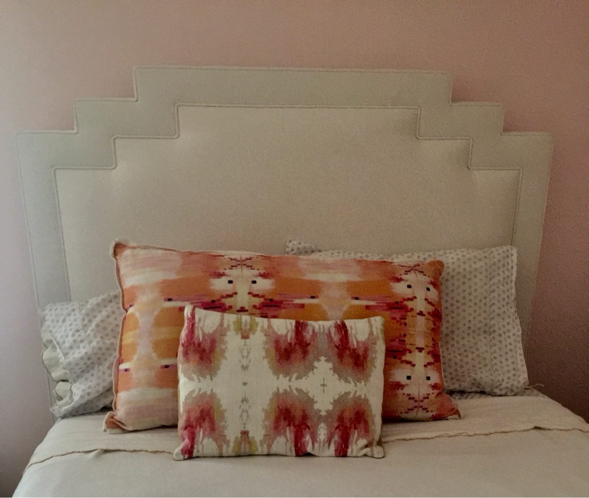 Stepped deco headboard, ikat pillows