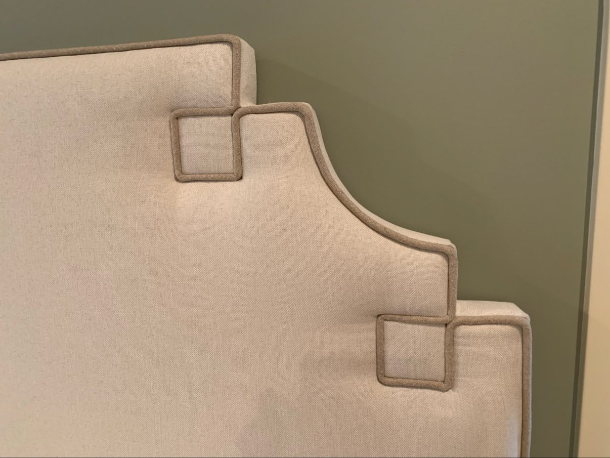 Headboard corner detail with Greek-key piping