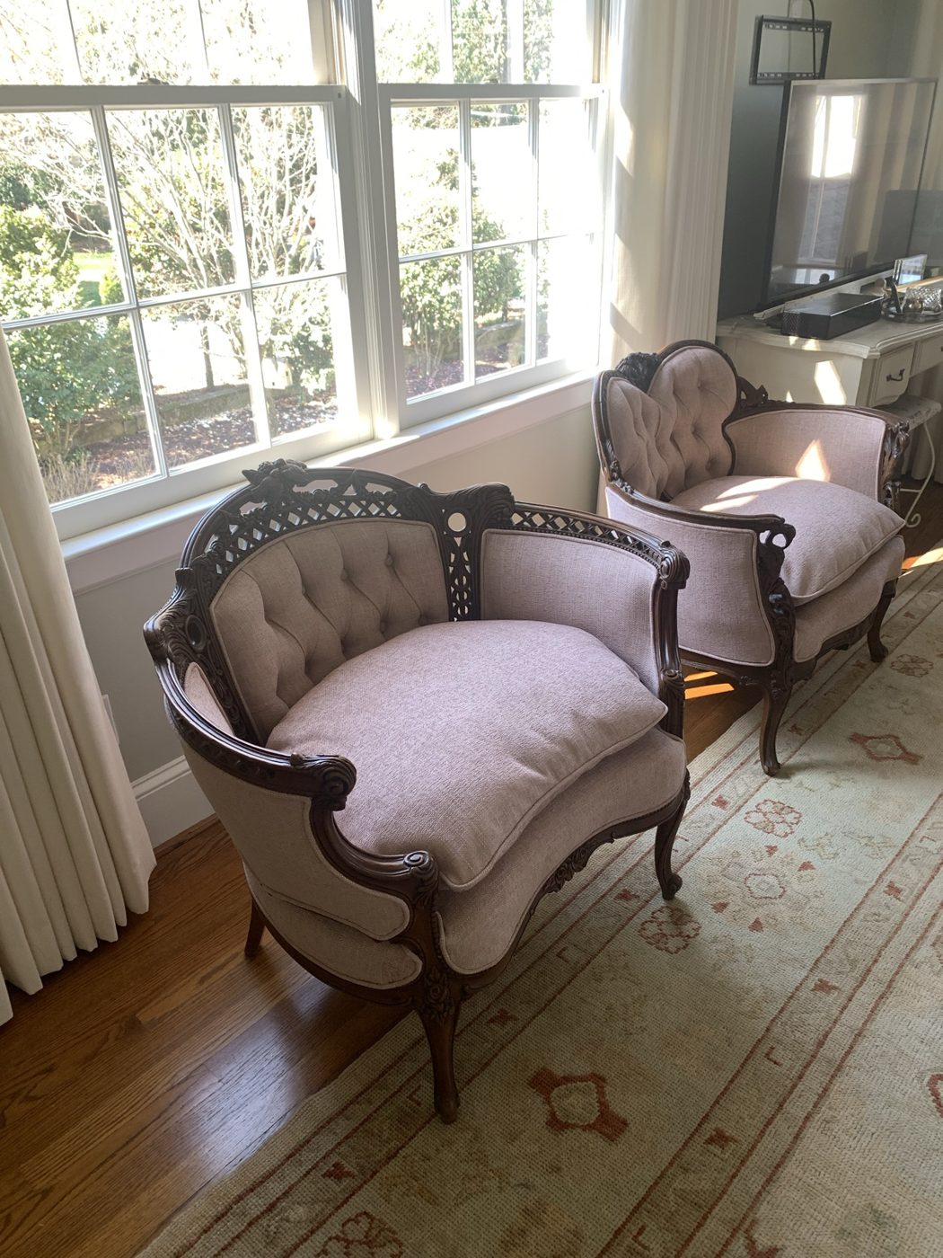 Carved antique-frame tufted chairs