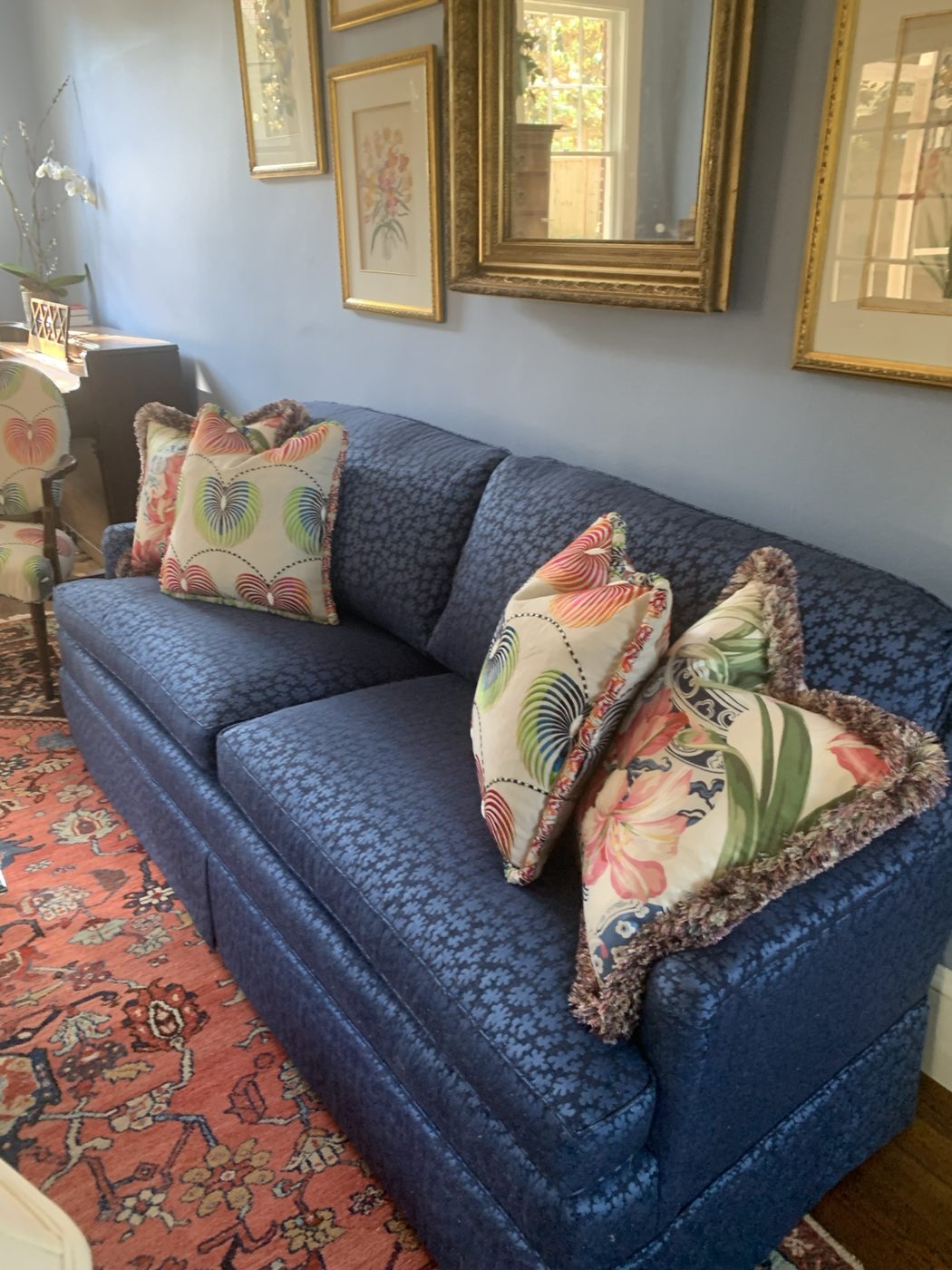 Navy sofa with floral pillows