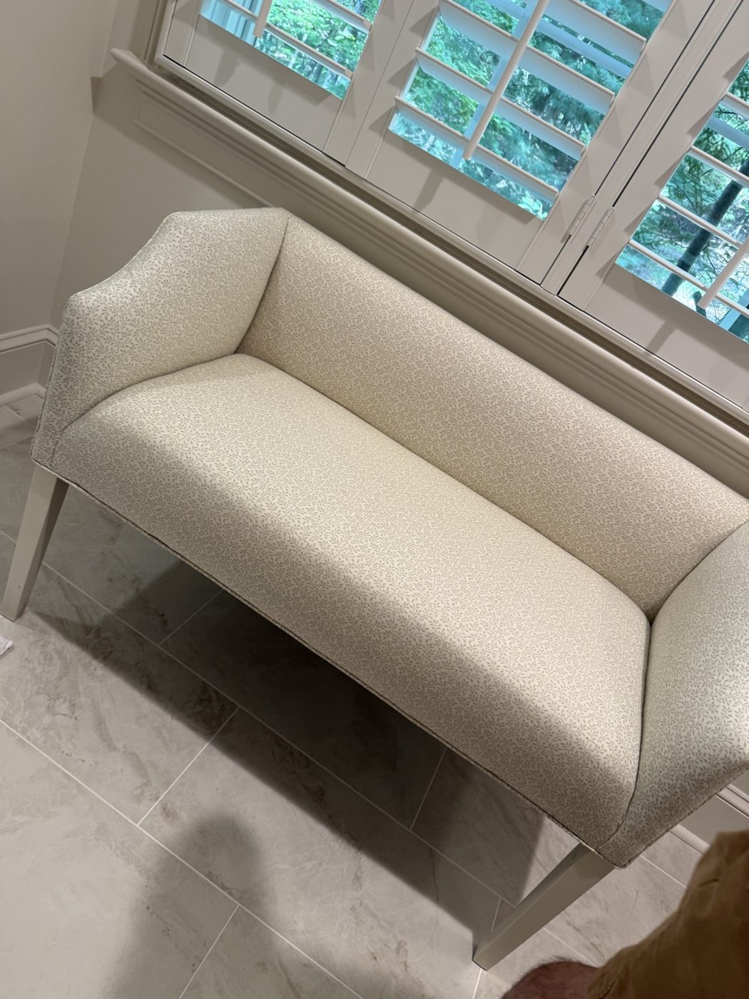 Cream settee under shutters