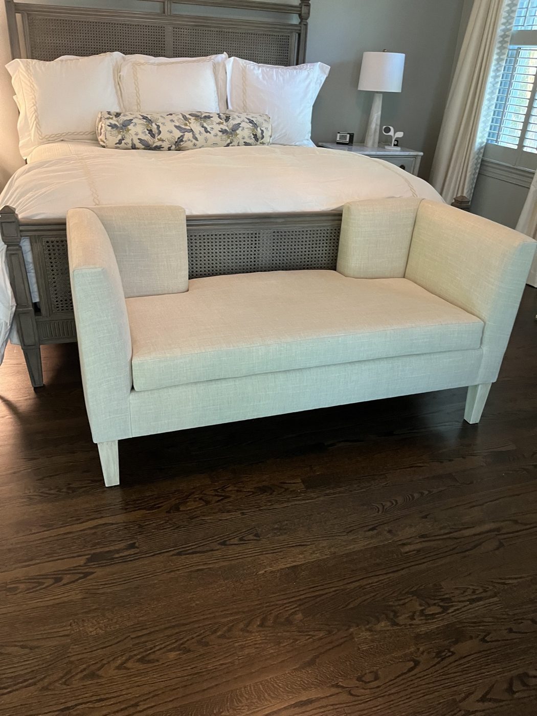 Cream settee at foot of bed