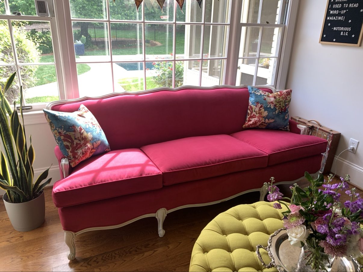 Raspberry pink sofa in sunroom