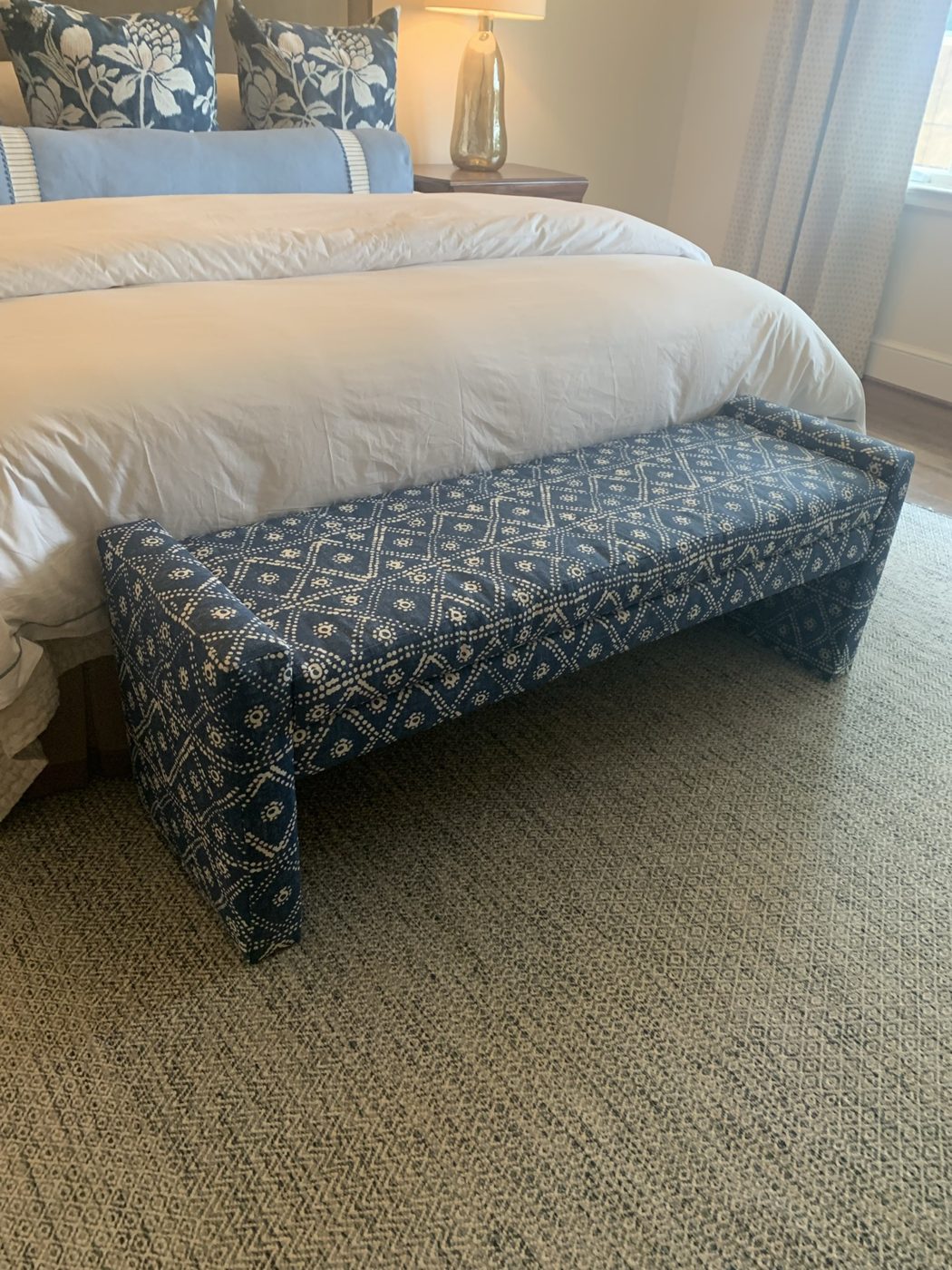 Blue patterned bench at foot of bed