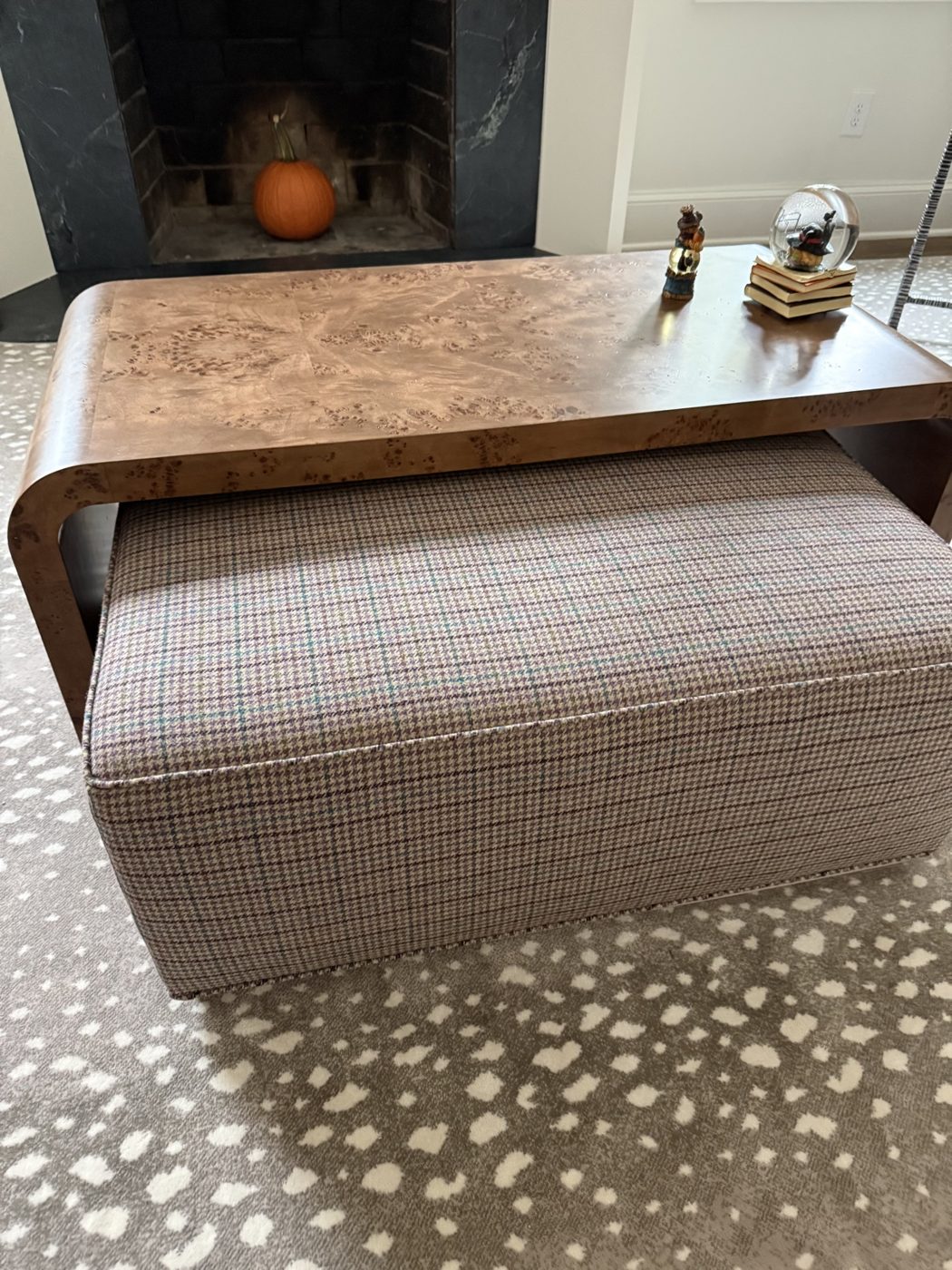 Houndstooth ottoman under burl coffee table