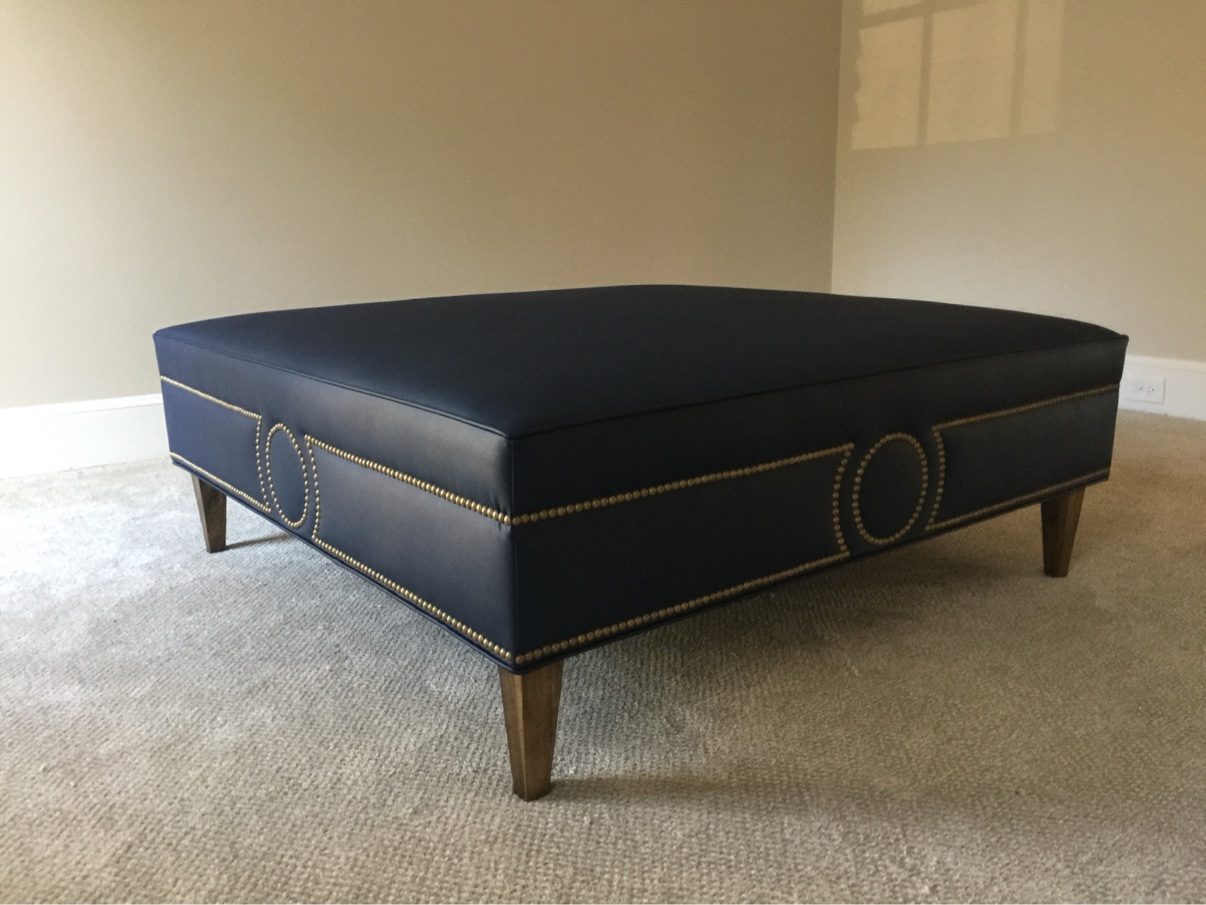 Navy leather ottoman with nailhead circles