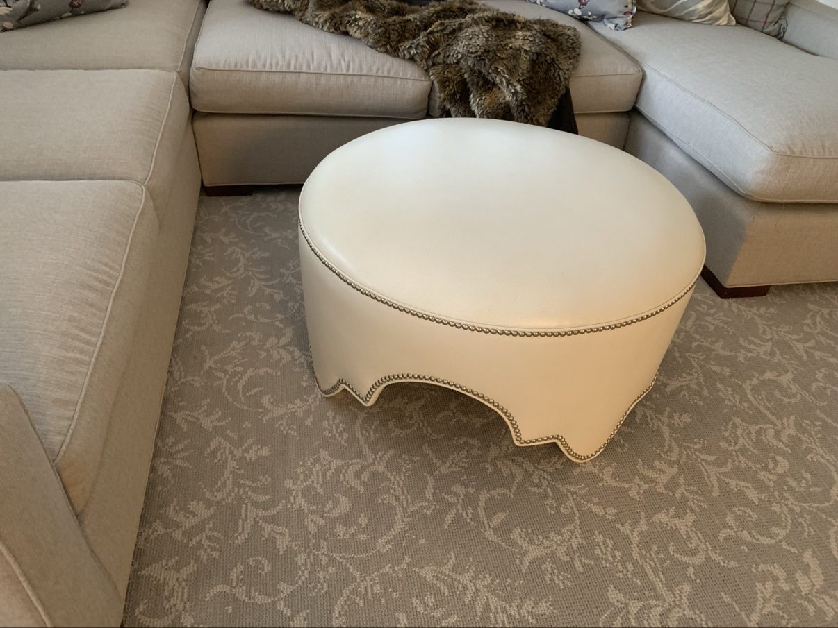 Scalloped white leather ottoman, in home
