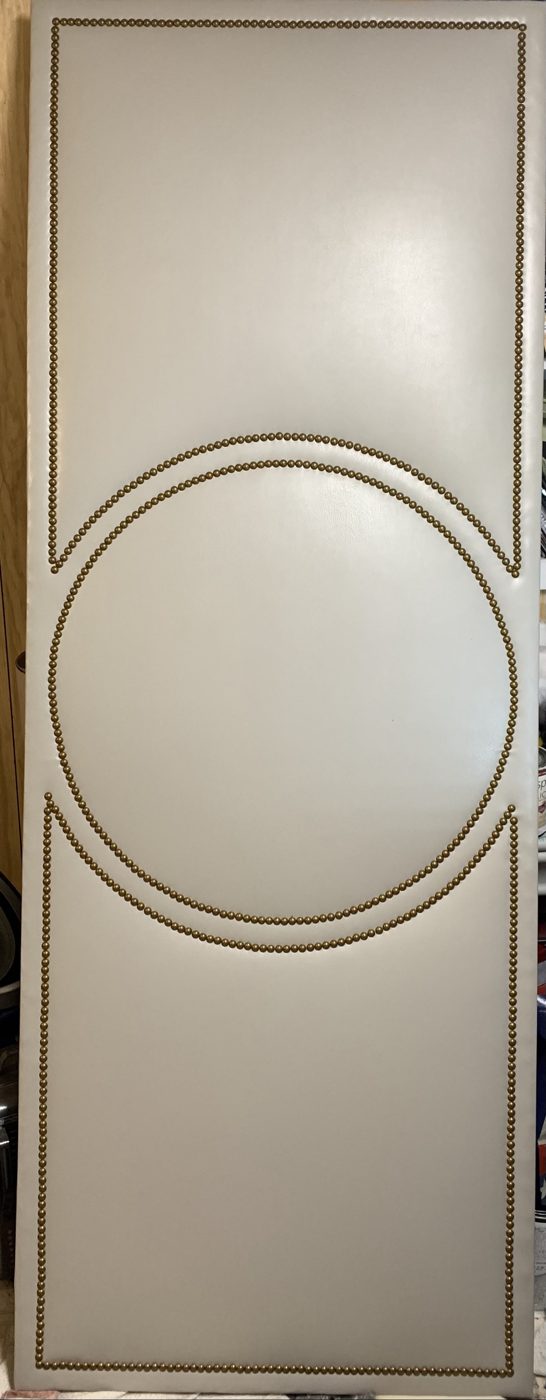 Cream upholstered door with circle motif