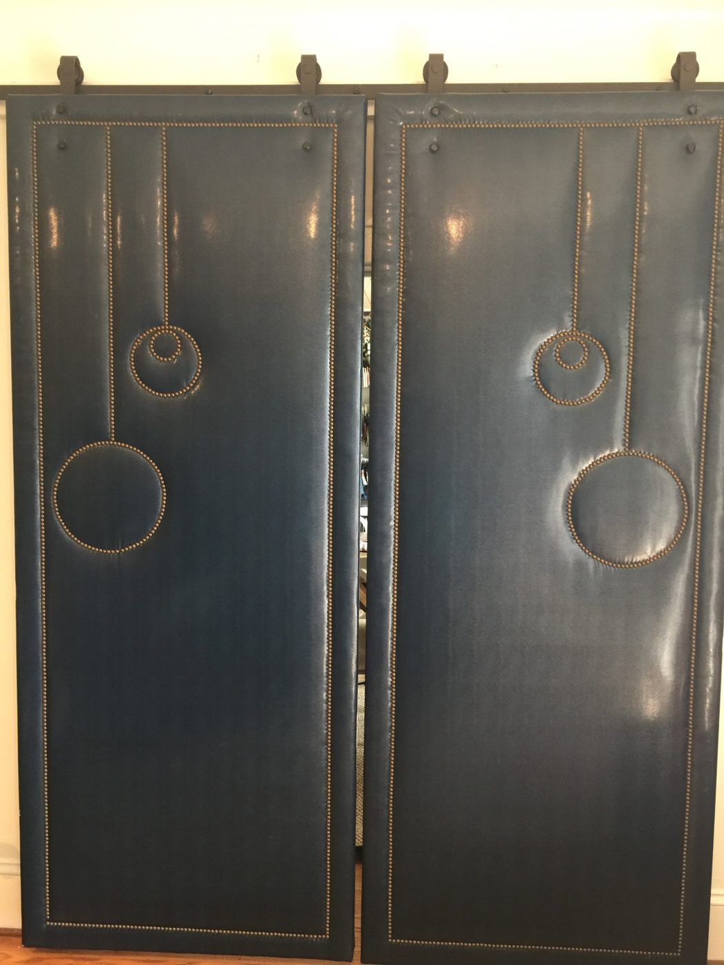 Blue barn doors with nailhead circles