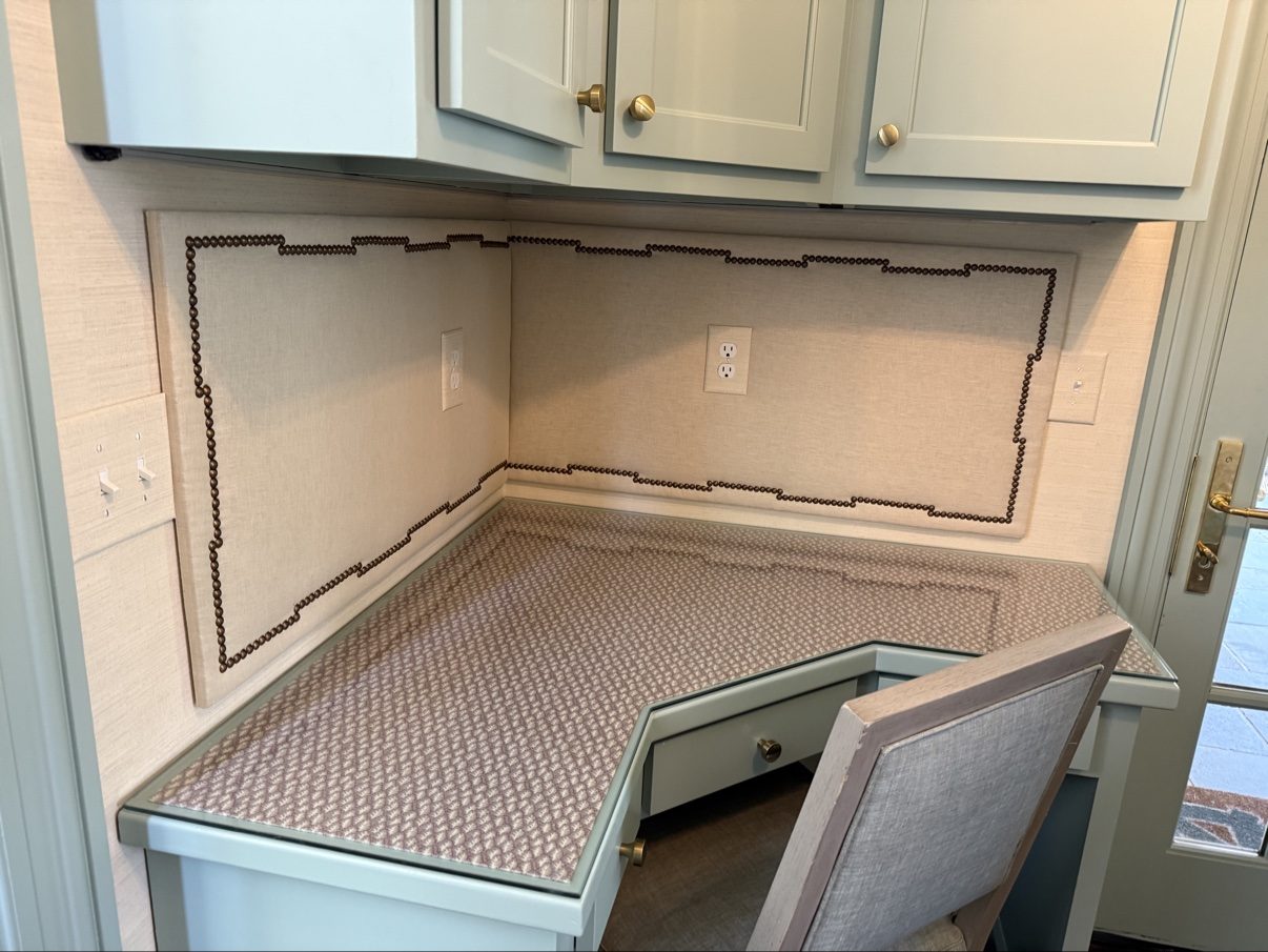 Kitchen desk nook with upholstered wall panels