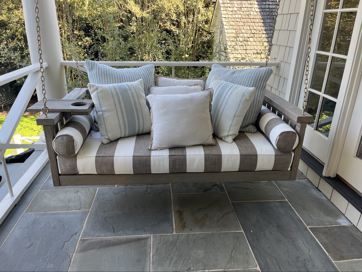 Porch swing with striped cushion