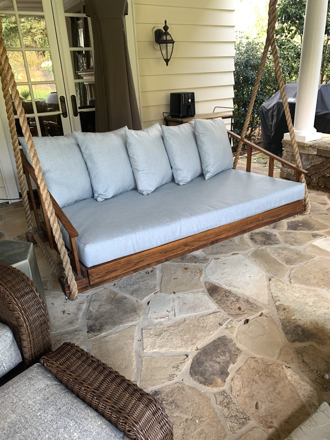 Porch swing bed with blue cushions