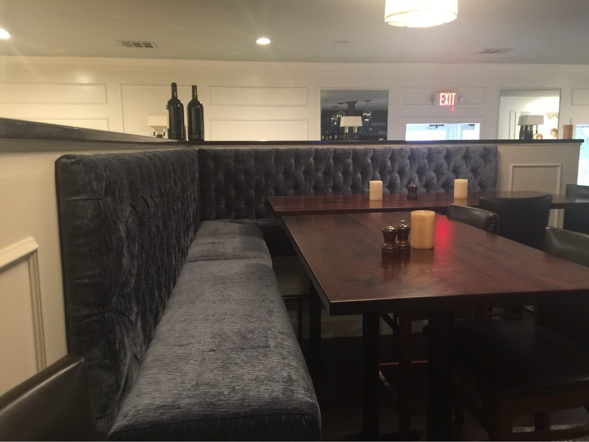 Restaurant tufted banquette with tables