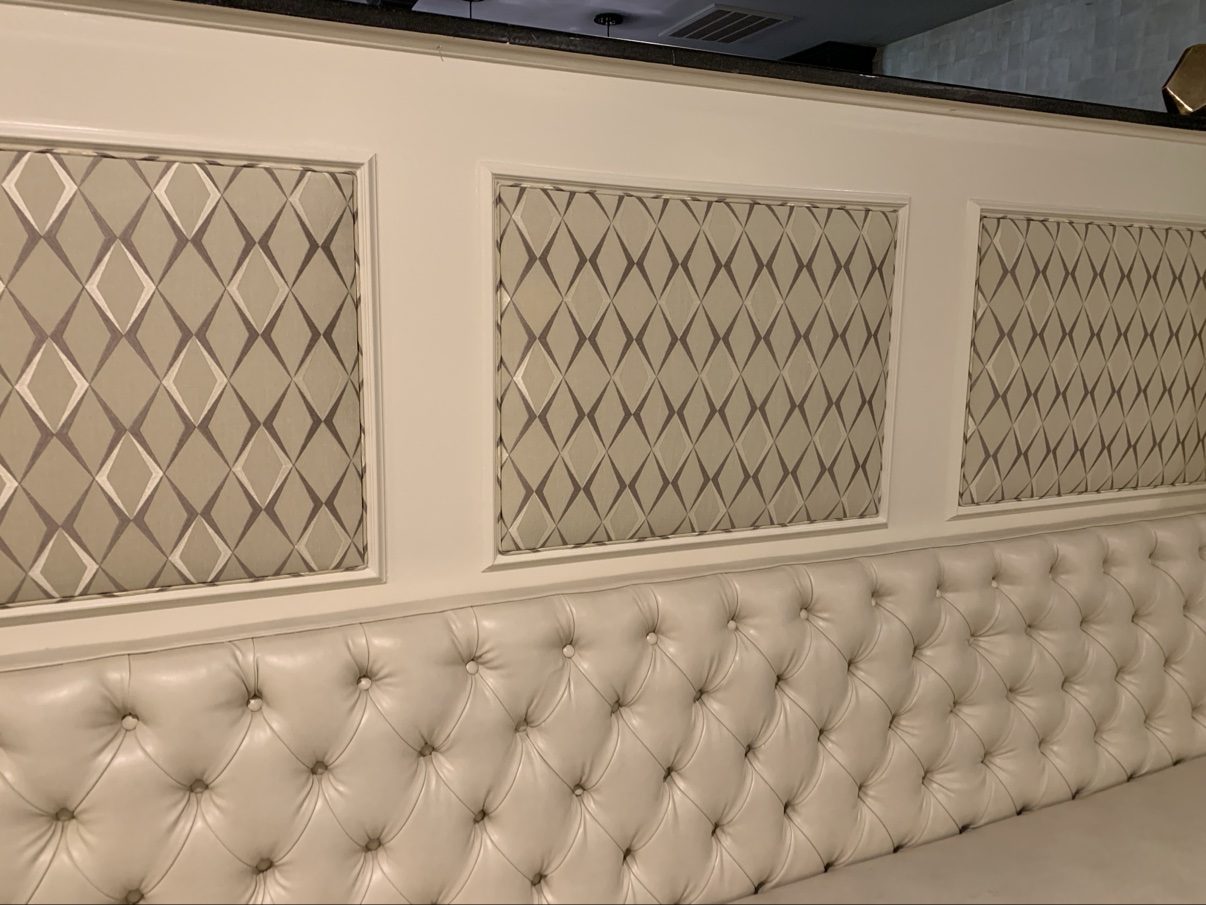 Wall panels above tufted banquette