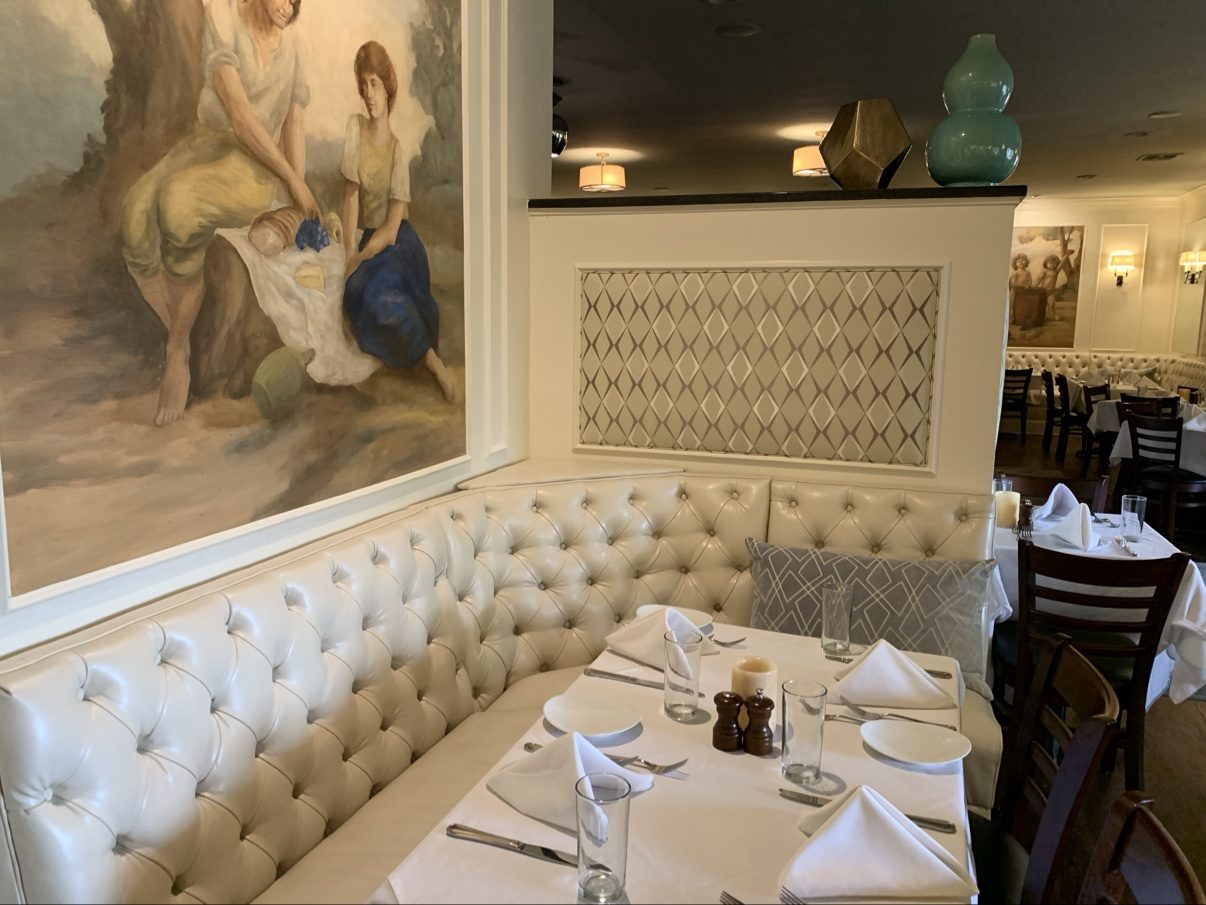 L-shaped tufted booth with mural