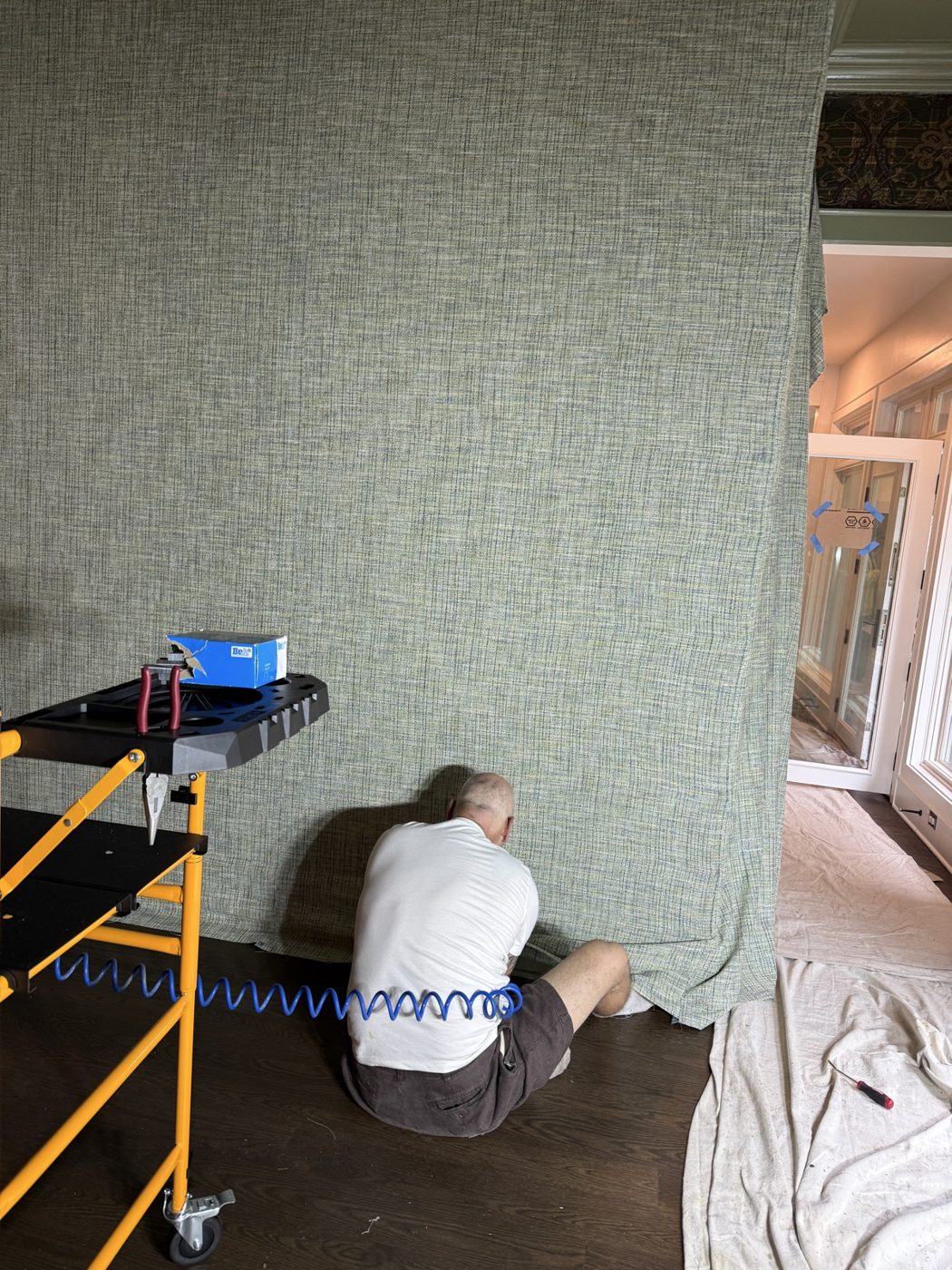 Upholstered fabric wall being installed