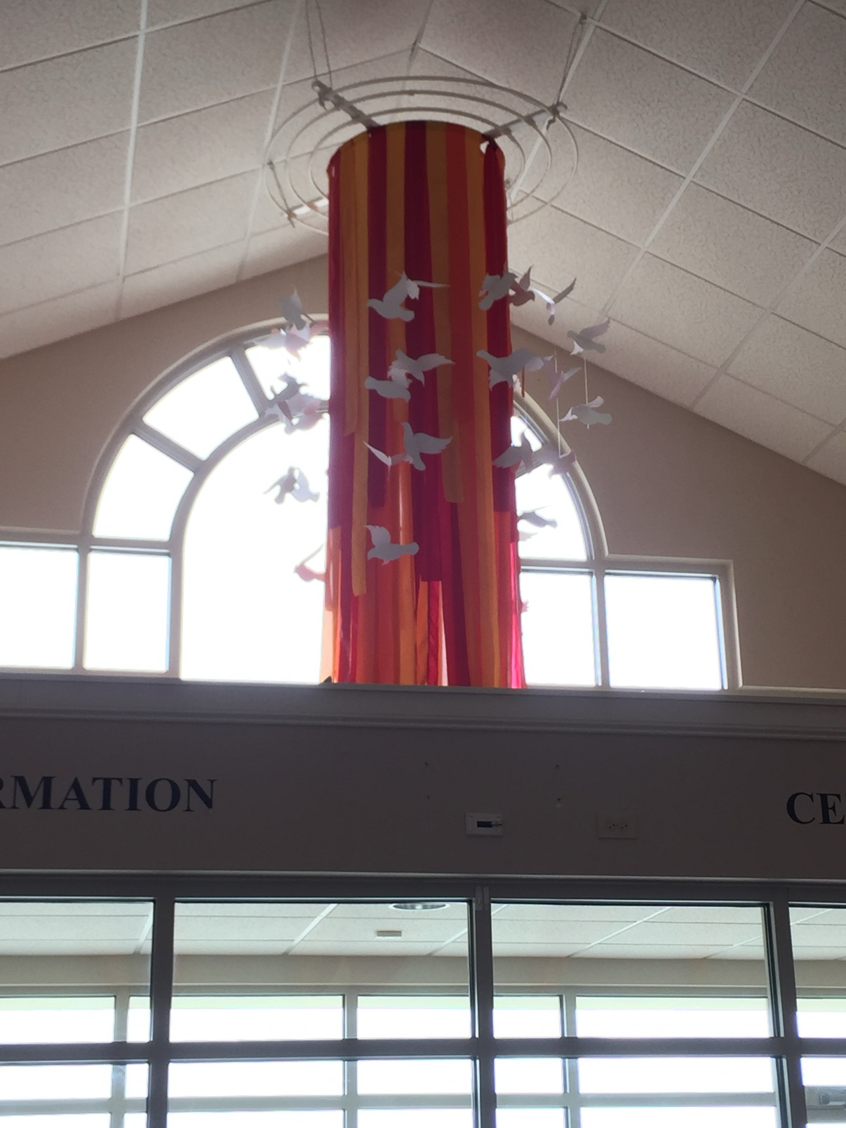 Fabric column installation with dove cutouts in a church lobby
