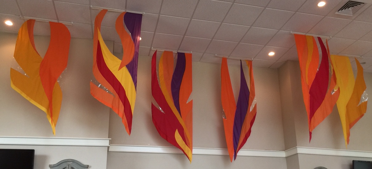 Colorful flame-shaped fabric banners on a church wall
