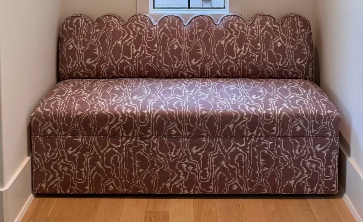 Patterned upholstered nook bench with scalloped back