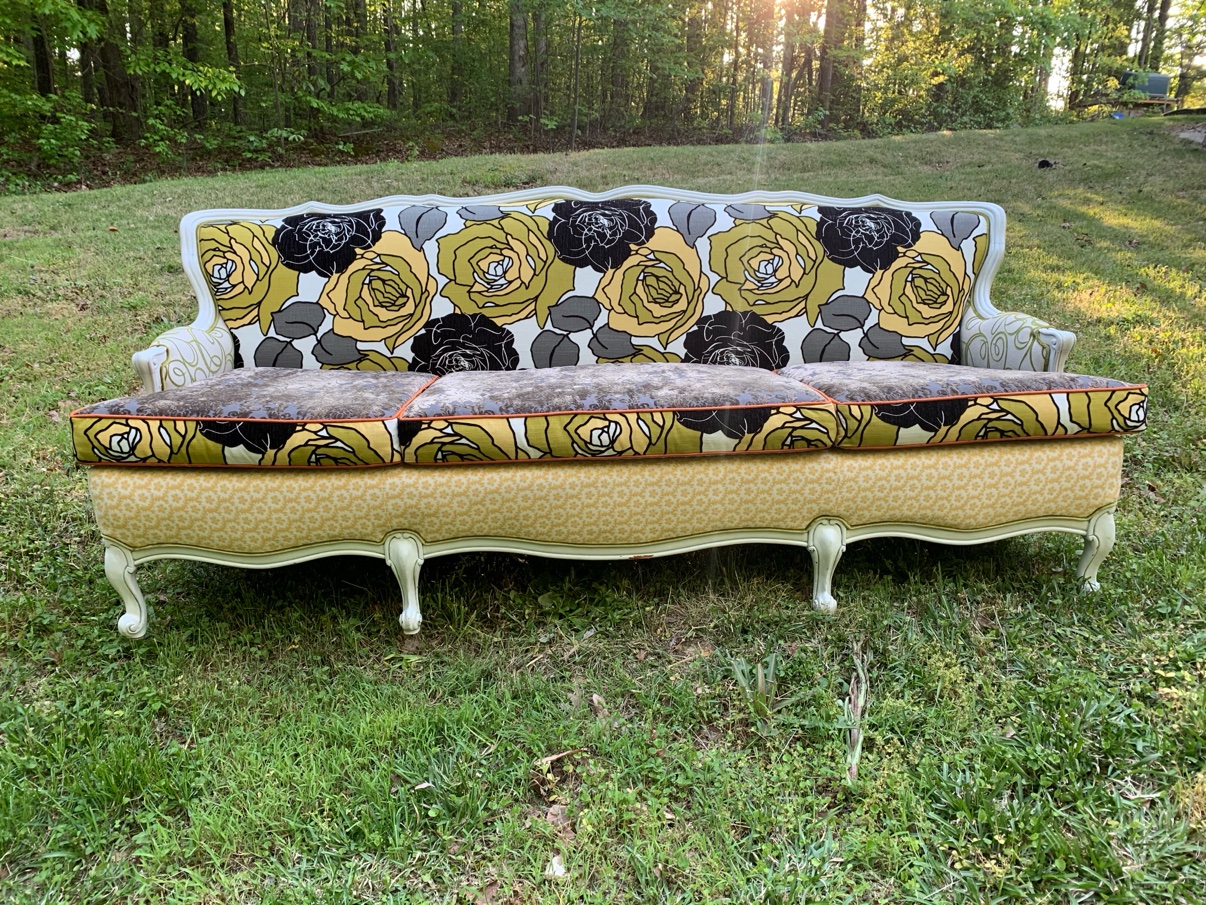 Floral upholstered sofa with yellow and black roses
